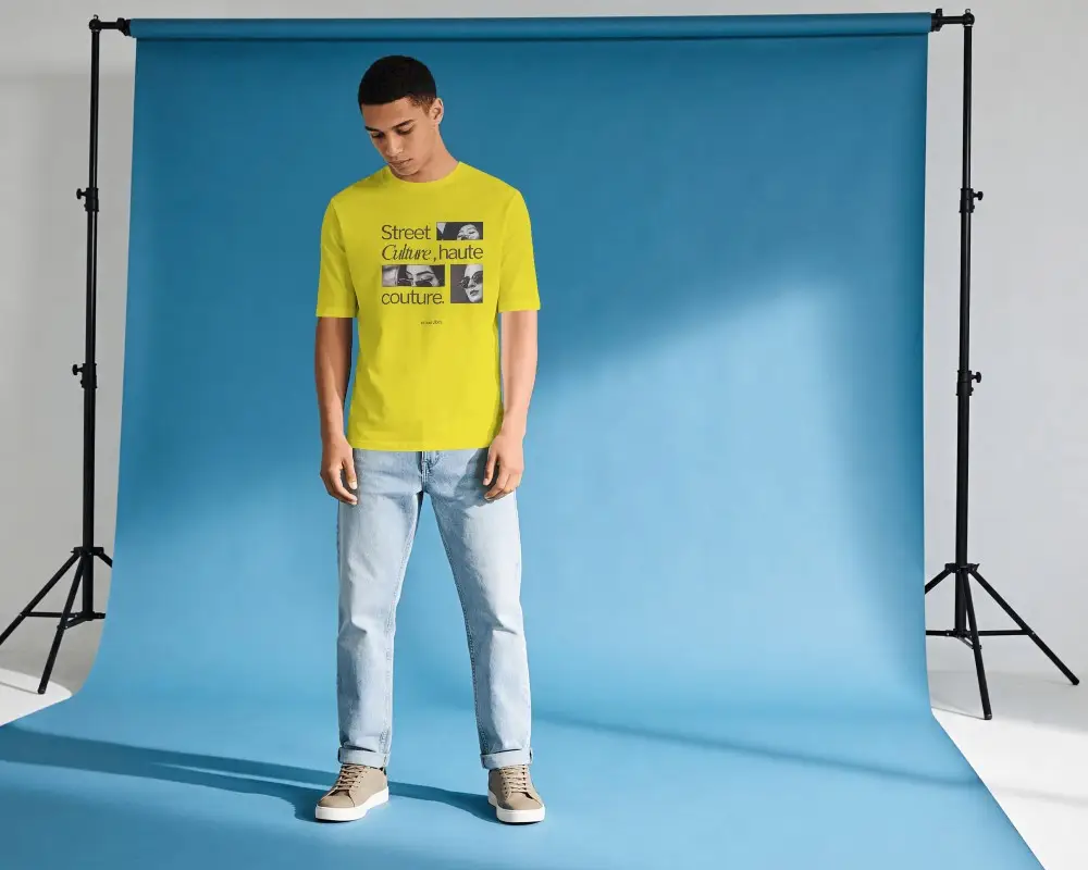 Studio T Shirt Mockup With Male Model Standing On Blue Backdrop And Clean Fashion Lighting