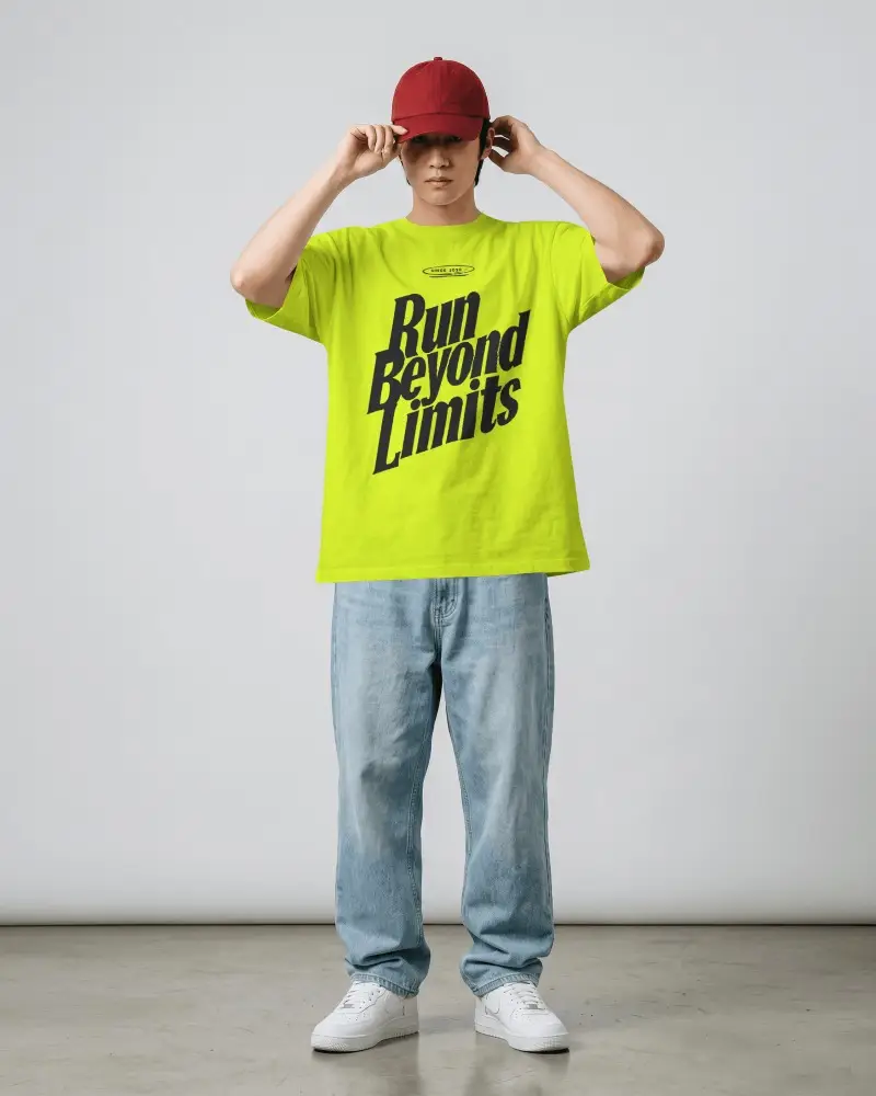 Red Cap Model Oversized T Shirt Mockup Standing Front View In Minimal Grey Studio Loose Denim Jeans