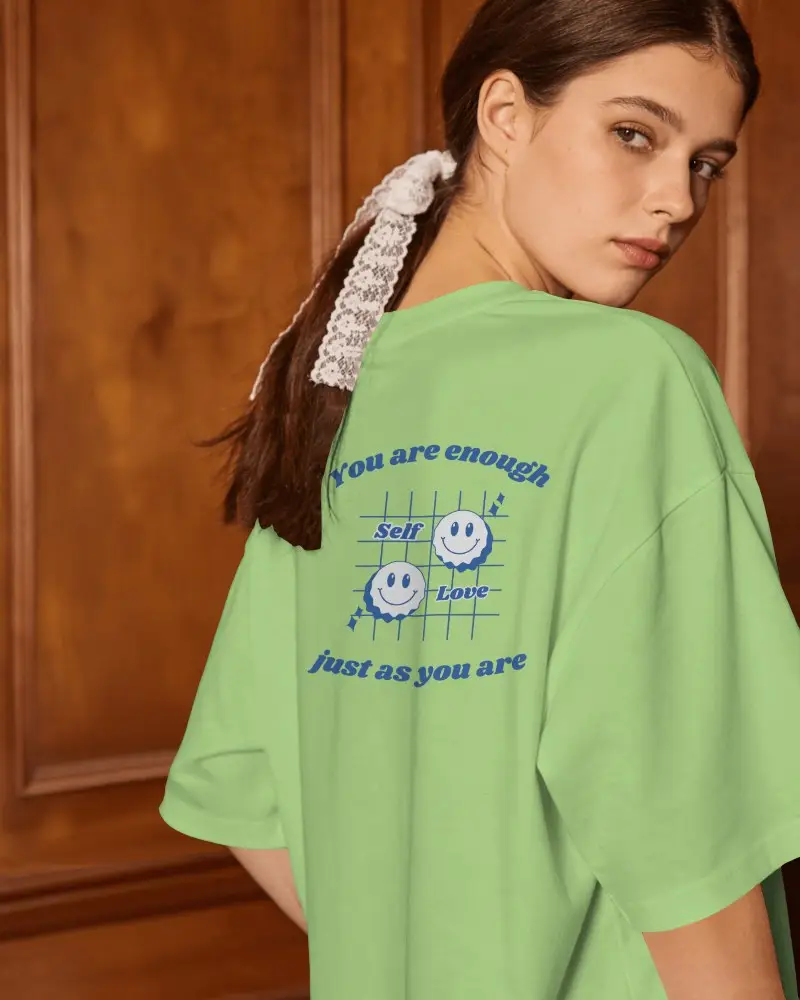 Back View T Shirt Mockup Female Model Looking Over Shoulder In Warm Wooden Interior Setting