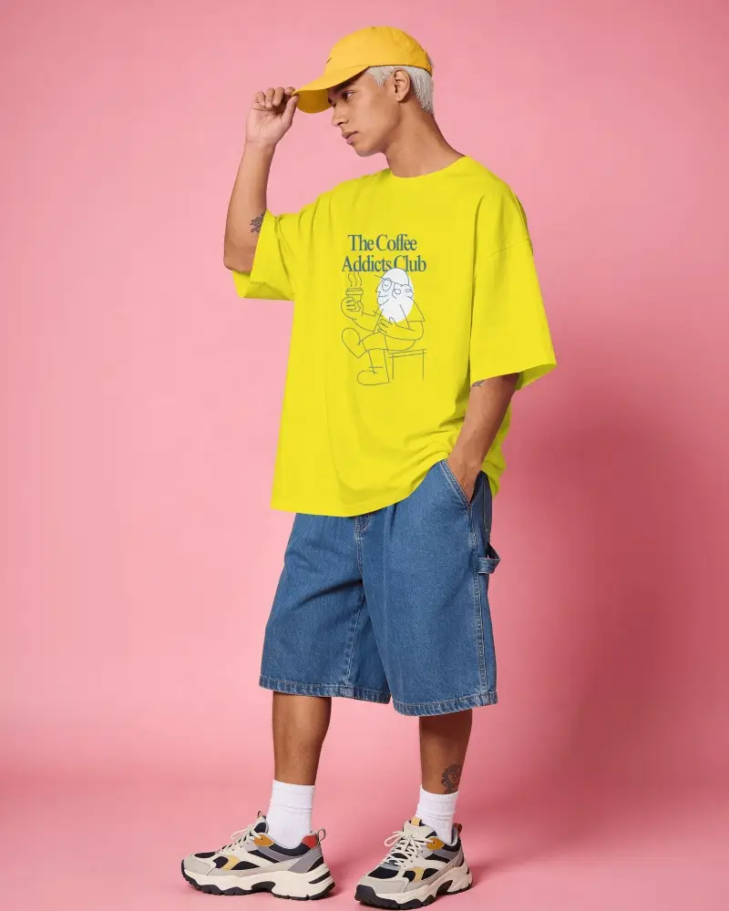 Oversized T Shirt Mockup Male Model In Denim Shorts Against Bold Color Studio Background