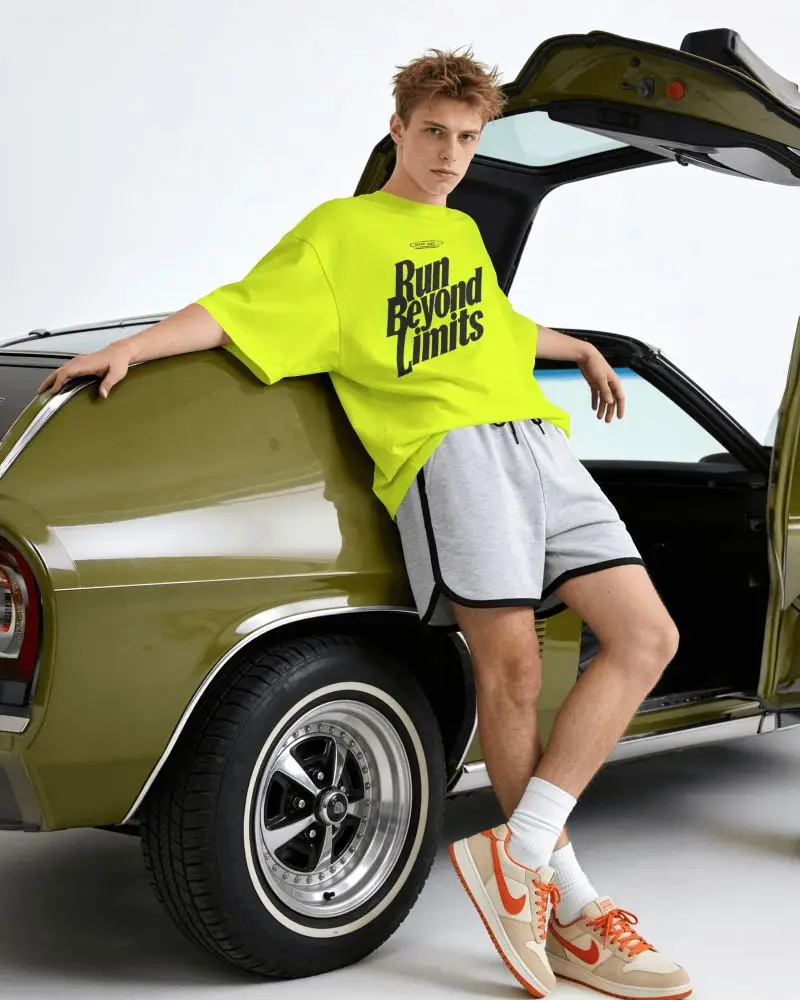 Vintage Car T Shirt Mockup Male Model Leaning On Classic Vehicle With Streetwear Attitude