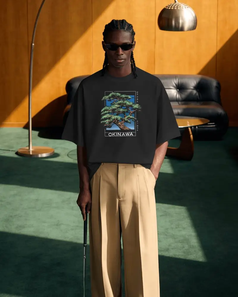 Retro Lounge T Shirt Mockup Male Model Wearing Sunglasses In Warm Wood Panel Interior