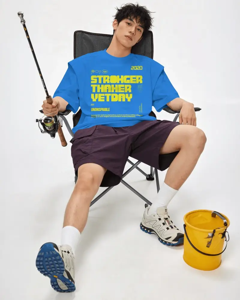 Fishing Lifestyle T Shirt Mockup Male Model Seated In Folding Chair With Casual Studio Pose
