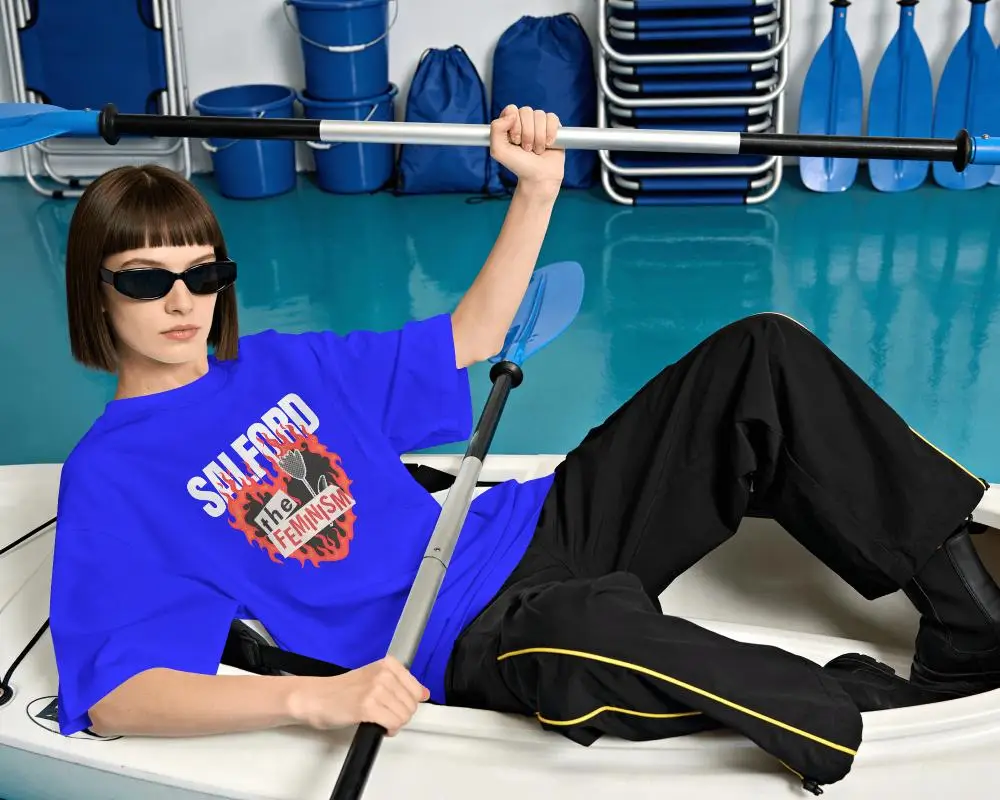Rowing Lifestyle T Shirt Mockup Female Model Reclining In Boat With Paddle And Sunglasses