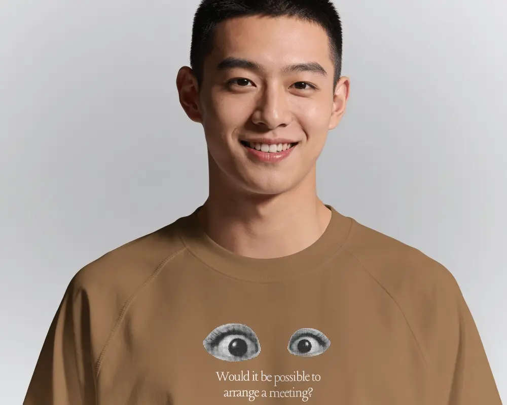 Close Up T Shirt Mockup Male Model Smiling In Clean Studio With Soft Portrait Lighting