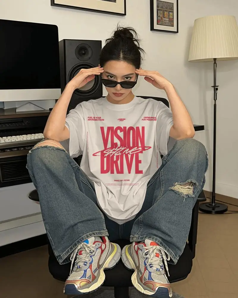 Casual Oversized T Shirt Mockup Seated Female Model With Denim Jeans And Sneakers