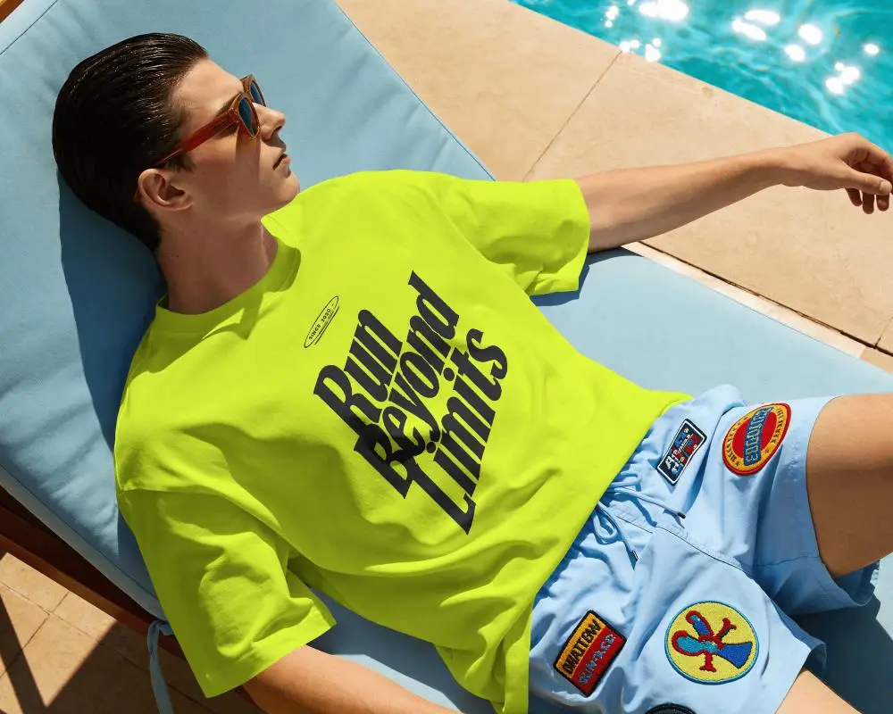 Poolside Lifestyle T Shirt Mockup Male Model Relaxing On Blue Lounger In Bright Summer Sunlight