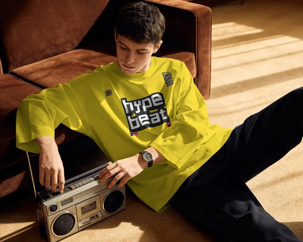 Retro Indoor T Shirt Mockup Male Model Sitting On Carpet With Vintage Boombox And Warm Sunlight