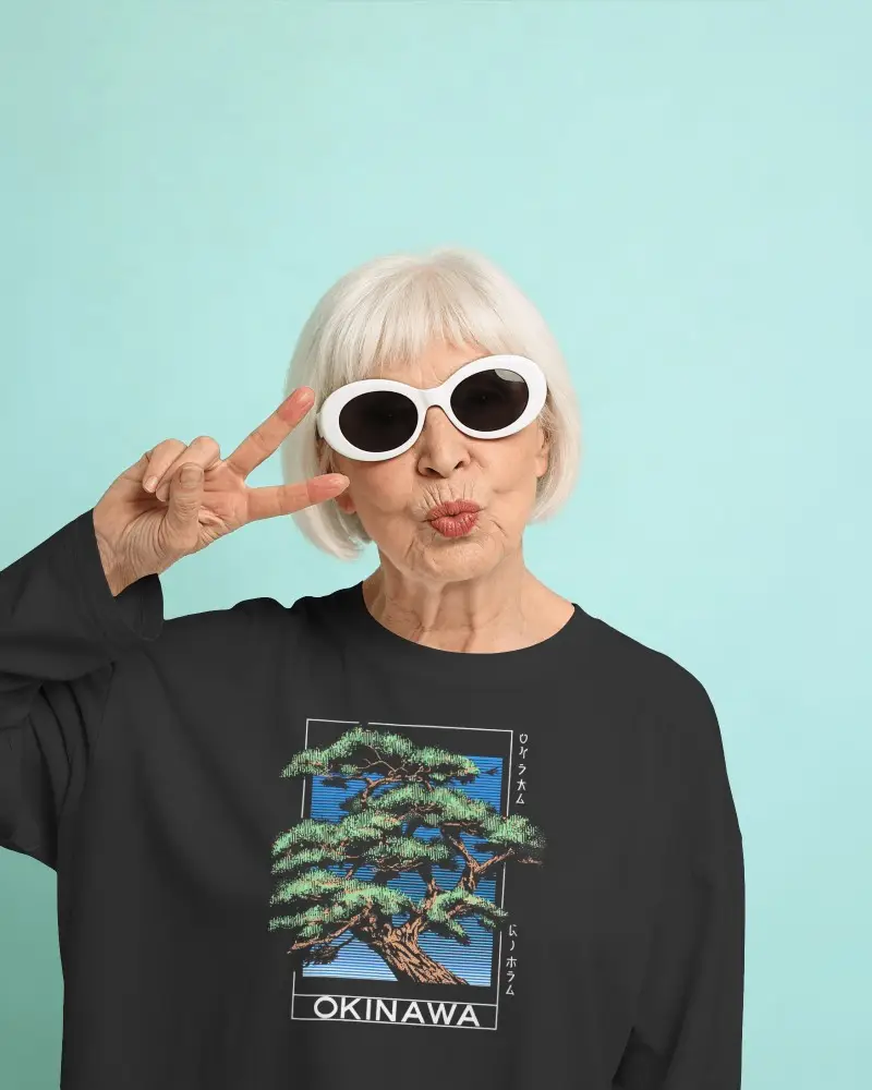 Playful Studio T Shirt Mockup Older Female Model Making Peace Sign With Modern Retro Sunglasses