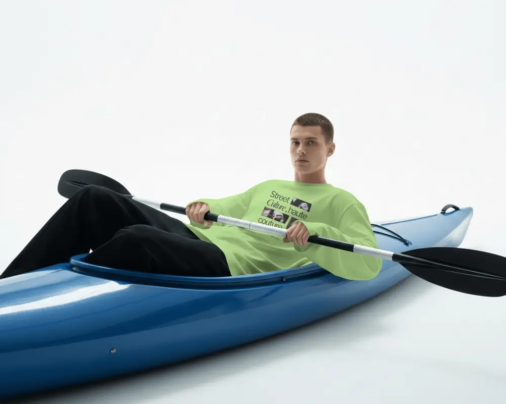 Kayak Adventure T Shirt Mockup Male Model Paddling Blue Kayak In Clean Minimal Studio Scene