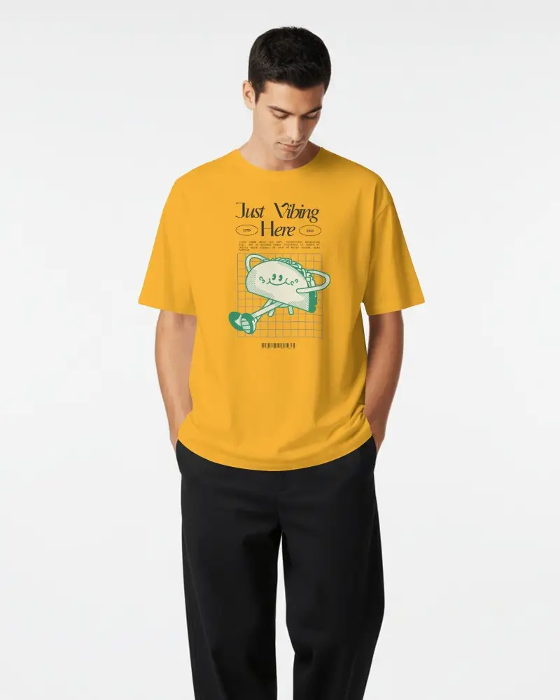 Minimal Studio T Shirt Mockup Male Model Looking Down With Hands In Pockets And White Studio