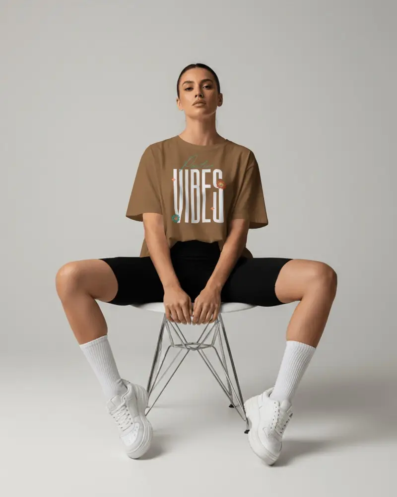 Premium Womens T Shirt Mockup Front View Seated Model With Black Shorts White Socks And Sneakers