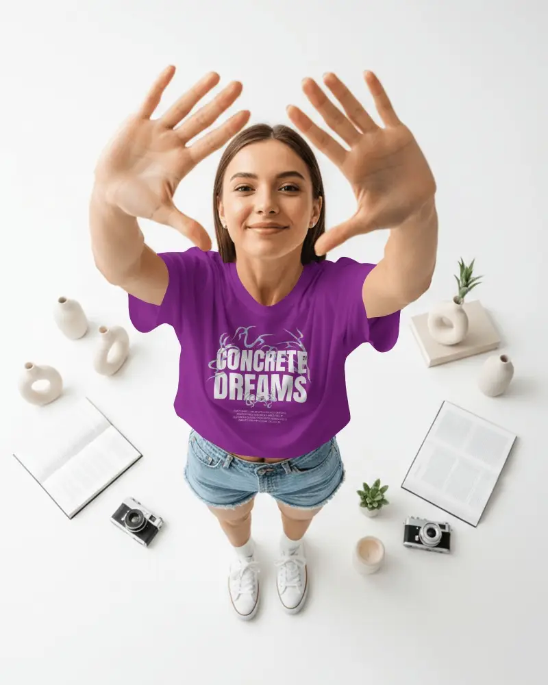 Overhead Perspective T Shirt Mockup Female Model Reaching Toward Camera In Bright Minimal Studio