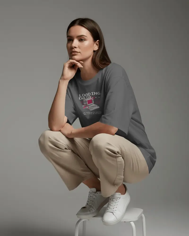 Minimal Studio T Shirt Mockup Female Model Crouching On Stool With Relaxed Casual Pose