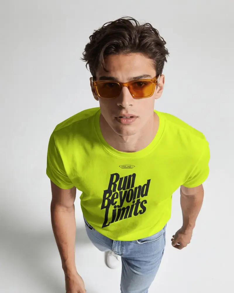 High Angle Mens T Shirt Mockup With Model Leaning Toward Camera In Minimal Studio