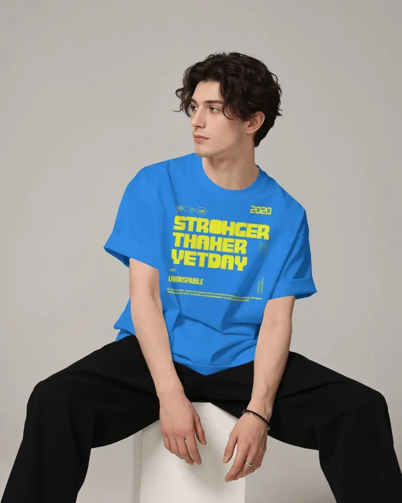 Oversized Crew Neck T Shirt Mockup On Male Model Sitting Casually On Geometric Pedestal