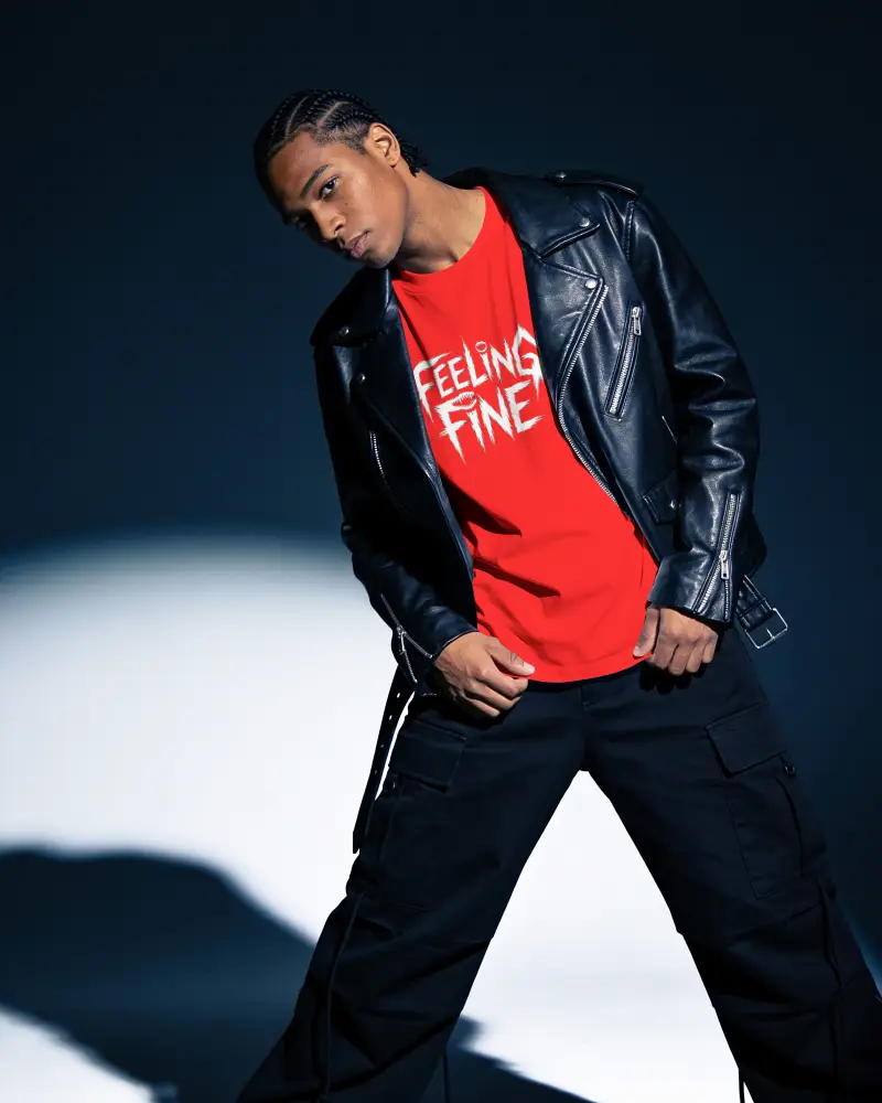 Angled T Shirt Mockup Male Model In Leather Jacket Striking Relaxed Studio Pose