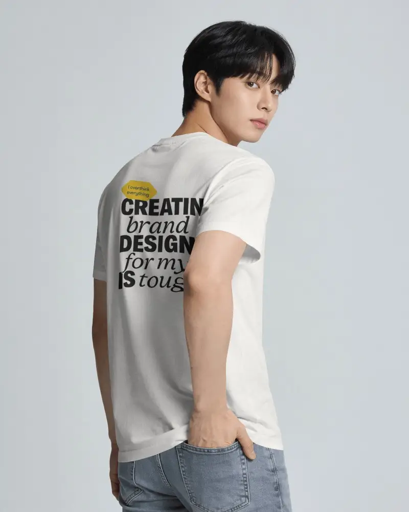 Three Quarter Back Mens T Shirt Mockup With Male Model Looking Over And Hand In Back Pocket