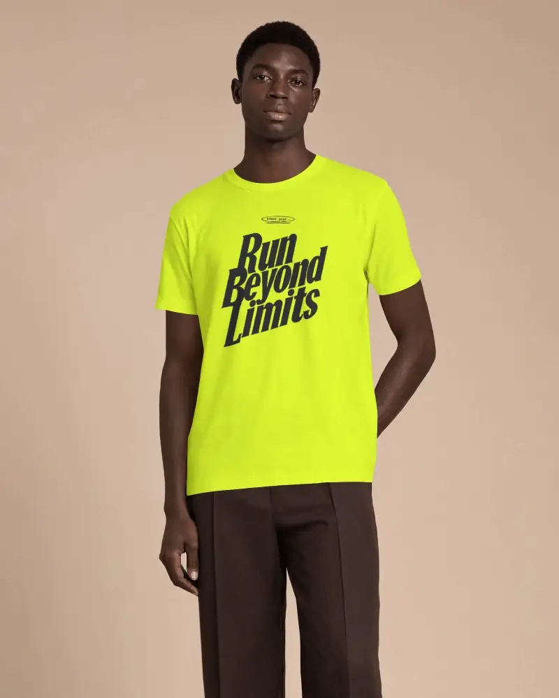 Front Facing Mens T Shirt Mockup With Tall Male Model Standing Relaxed And One Hand Behind Back