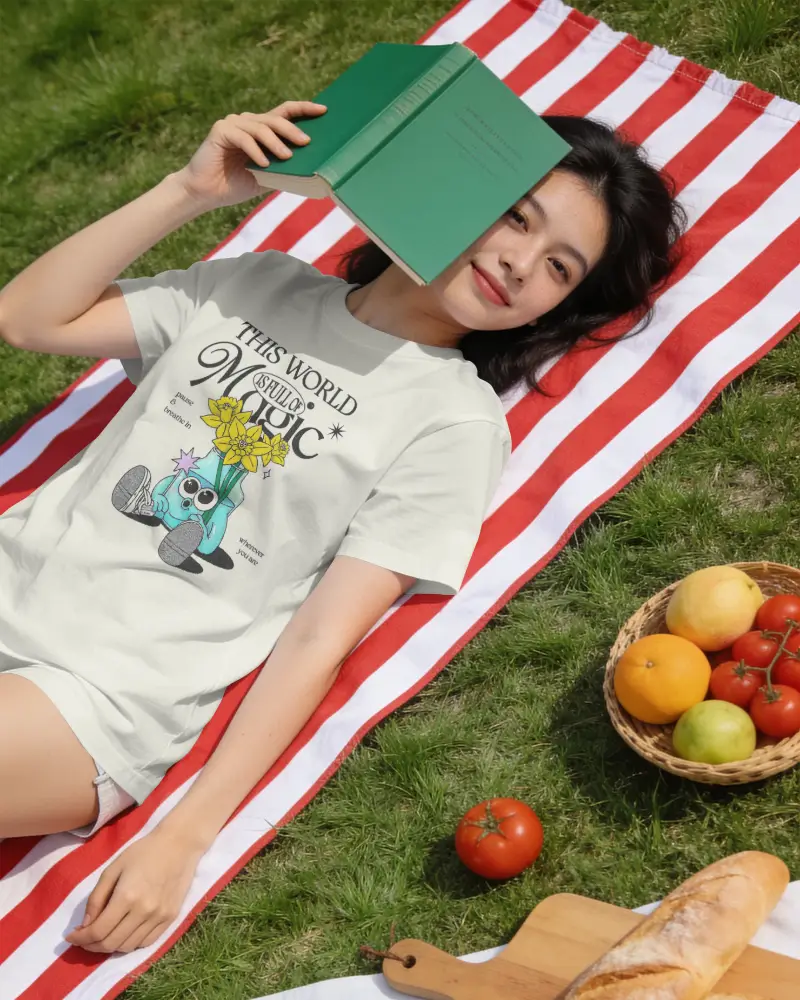 Outdoor Female T Shirt Mockup Lying On Picnic Blanket Reading A Book In Sunlight