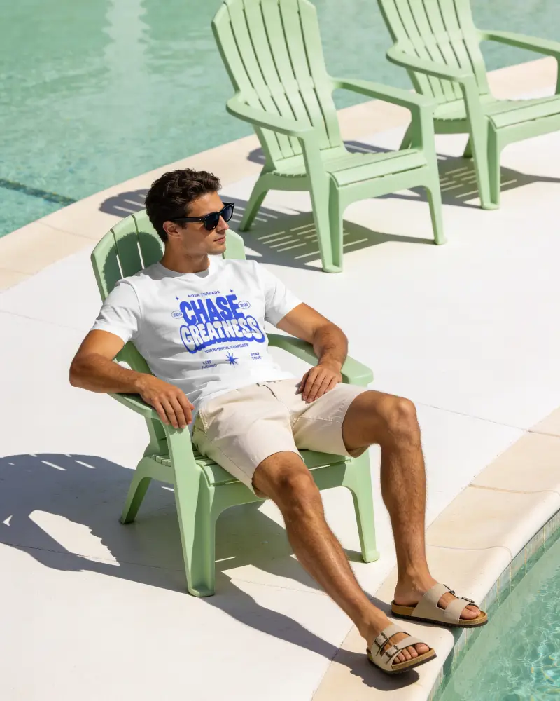 Poolside Male T Shirt Mockup Relaxing On Lounge Chair In Sunny Resort Setting