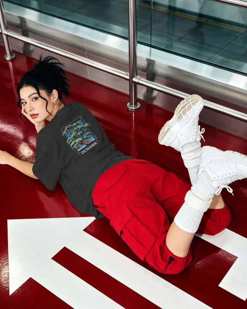 Trendy T Shirt Mockup Female Figure Tee Lying On Red Floor White Directional Markings Contemporary