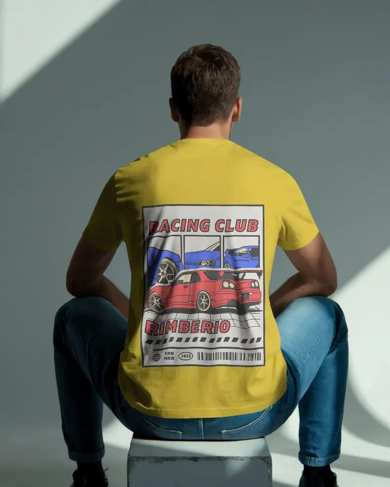 Natural Light Interior Tshirt Mockup Seated Man Facing Away With Soft Shadows On Blue Toned Wall