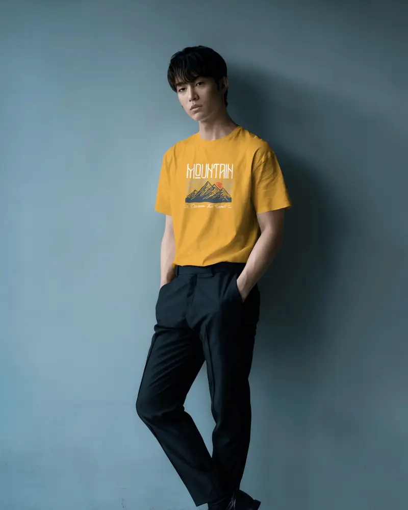 Casual Lean Tshirt Mockup Asian Male Model Hands In Pockets Minimal Blue Wall Background