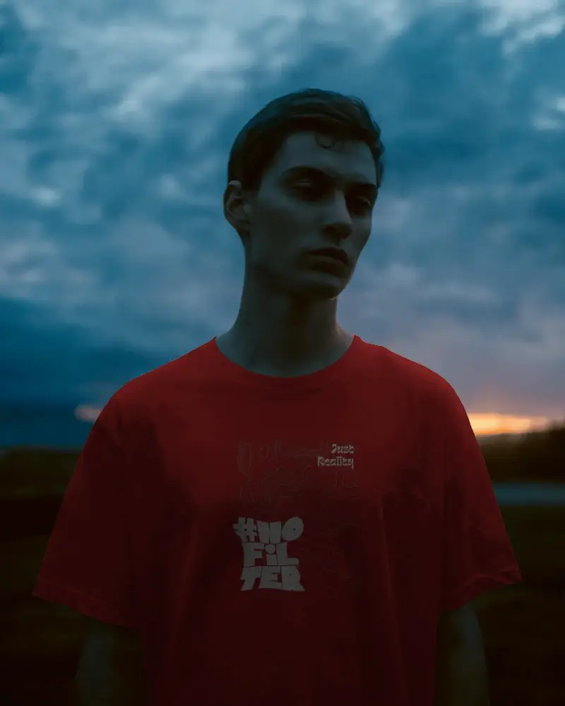 Moody Dusk T Shirt Mockup Male Model In Twilight Skyline Backdrop Brooding Contemporary Style
