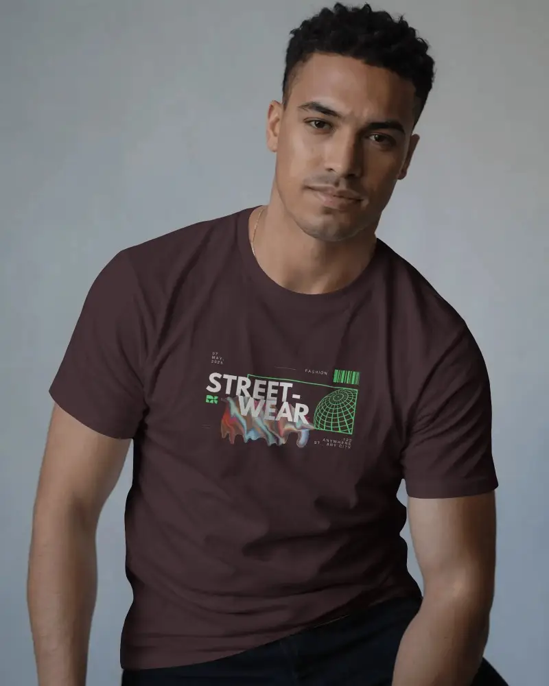 Relaxed T Shirt Mockup Male Model Sitting With Soft Smile Natural Studio Lighting Style