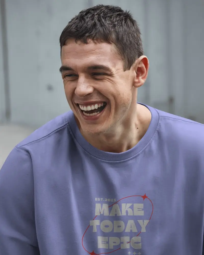 Urban Closeup Front View T Shirt Mockup Smiling Male Model In Boxy Grey Tee Natural Light Candid And Modern Streetwear Vibe