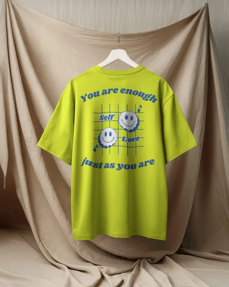 Boxy Blank White Round Neck Unisex T Shirt Mockup Back View On Hanger Draped Fabric Backdrop Soft Neutral Lighting Minimal And Elegant Presentation