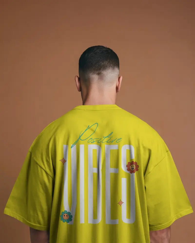 Studio Back View Tshirt Mockup Male Model Wearing Oversized White Tee On Warm Backdrop 