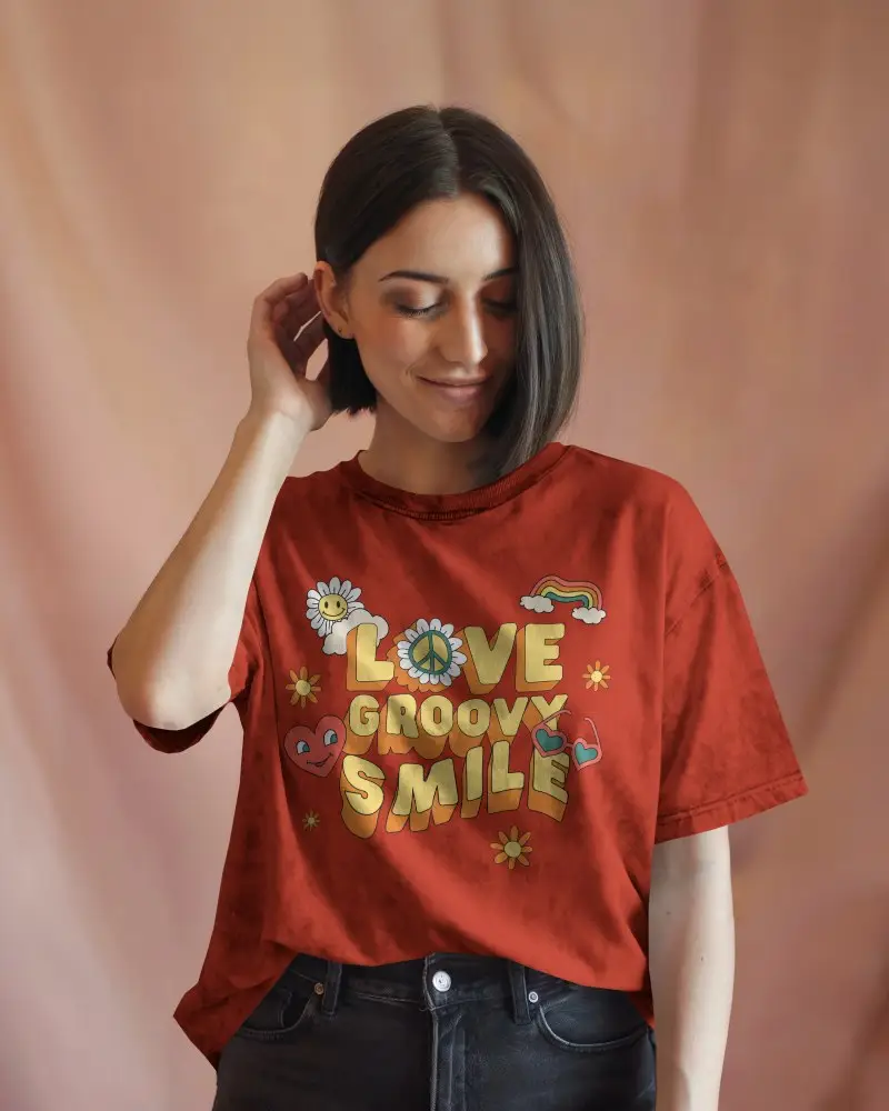 Acid Wash T Shirt Mockup Female Model Touching Hair Soft Smile On Rosy Backdrop Relaxed And Casual Styling