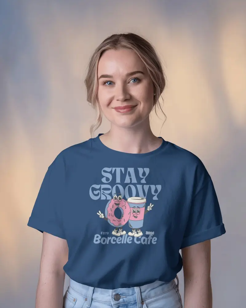 Smiling Woman Presenting T Shirt Against Soft Focus Background
