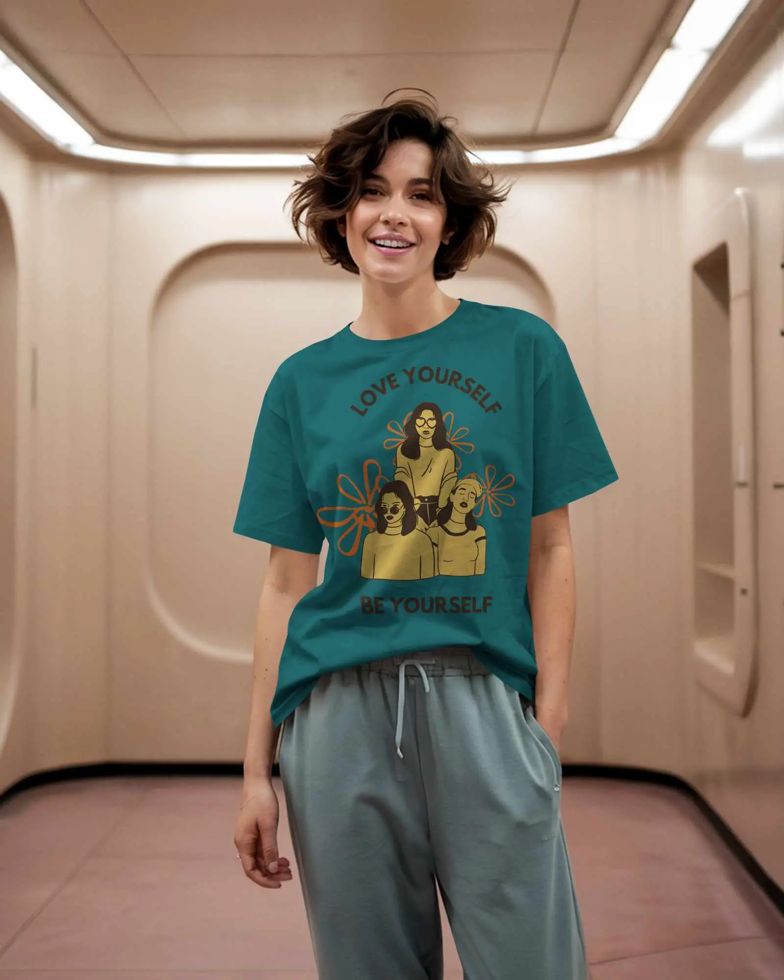 Indoor T Shirt Mockup Female Model In Relaxed Fit Tee And Joggers Smiling In Futuristic Hallway Casual And Playful Vibe