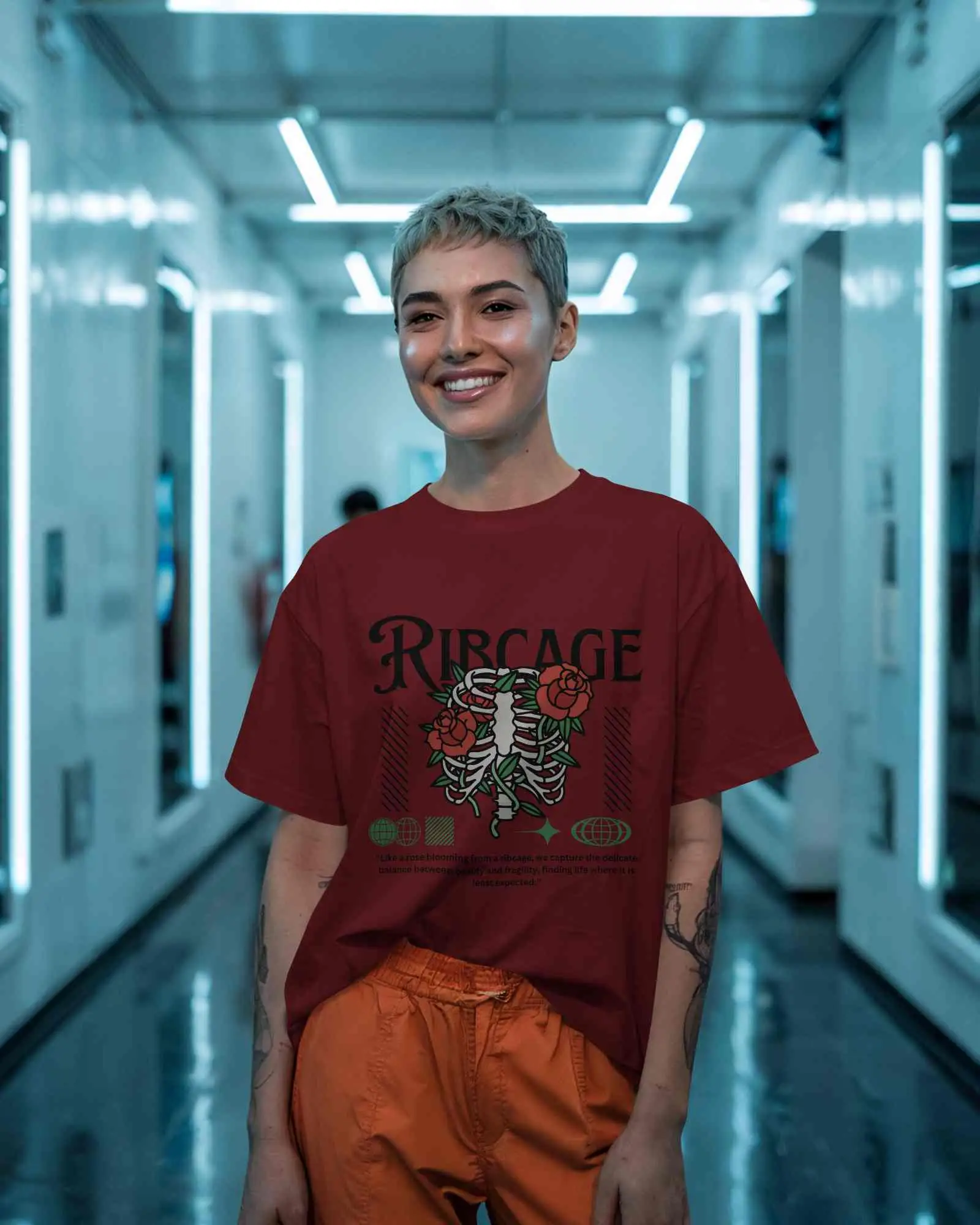 Futuristic Hallway T Shirt Mockup Female Model In Relaxed Fit Tee And Orange Pants Smiling Under Neon Lights Bold And Modern Look