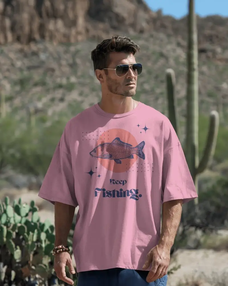 Desert Outdoor Tshirt Mockup With Male Model In Oversized White Tee Among Cactus And Rocky Background
