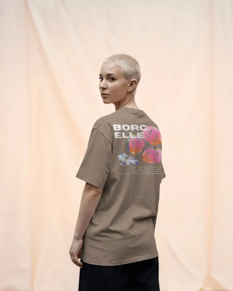 Edgy And Clean Tshirt Mockup Featuring Woman In Back Facing Pose Against Draped Peach Fabric Background