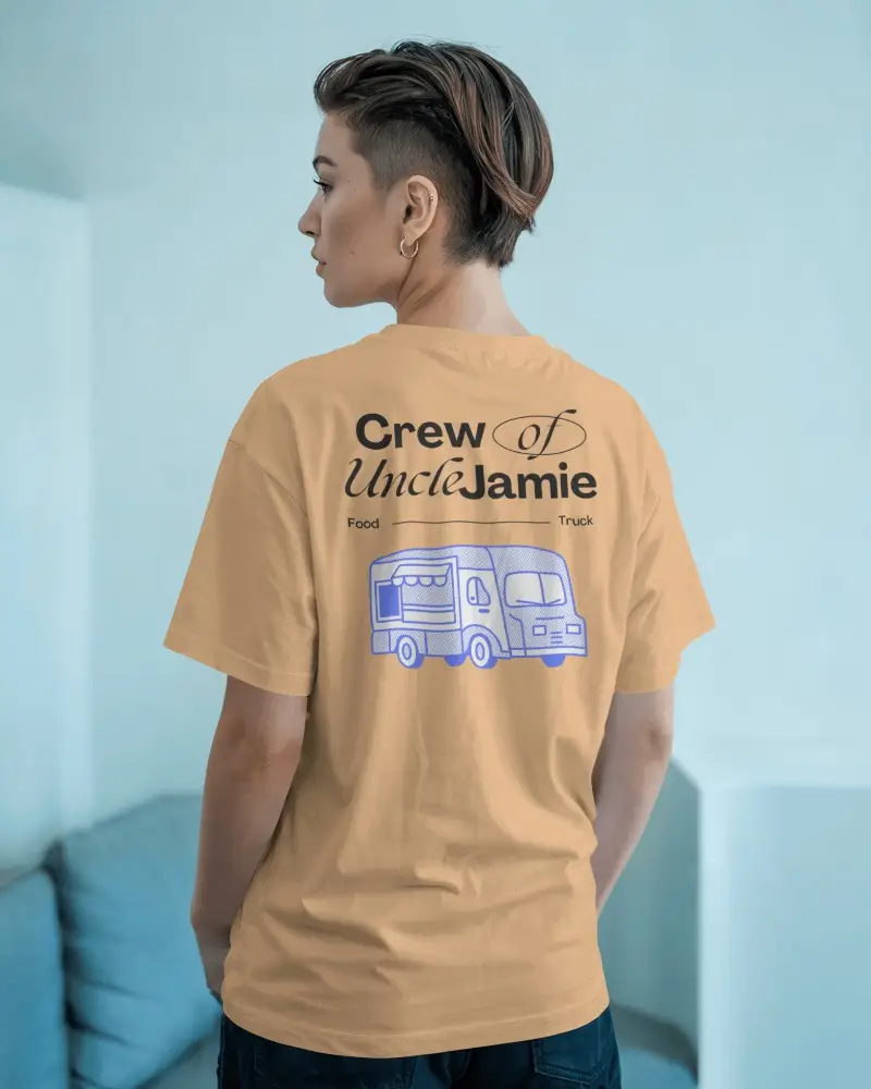 Stylish Back Design Tshirt Mockup Featuring Woman In Minimal Living Space With Light Toned Wall And Couch