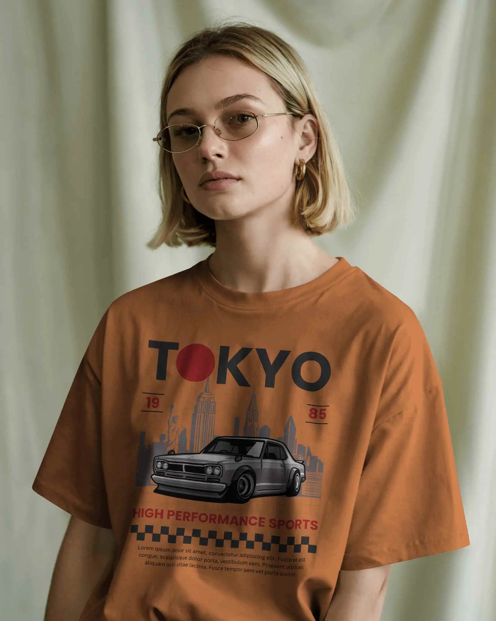 Soft Studio Light T Shirt Mockup Female Model With Blonde Bob Hair And Glasses Wearing Grey Tee In Calm Neutral Setting