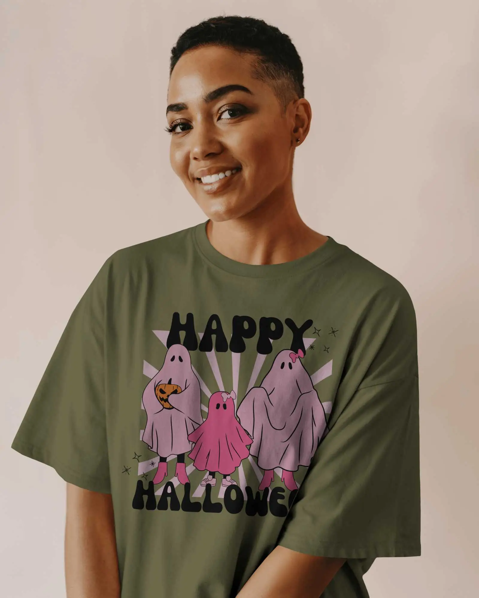 Warm Neutral Background T Shirt Mockup Smiling Female Model With Buzzcut Wearing Grey Tee In Soft Studio Light