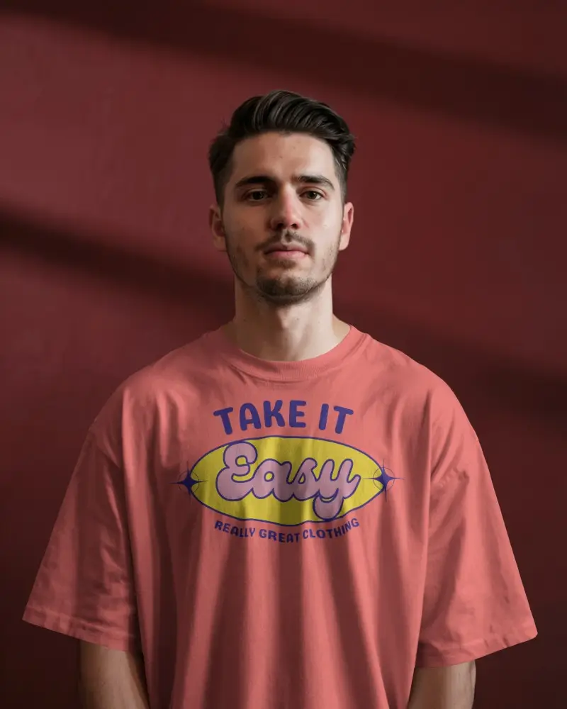 Sunlit Interior Tshirt Mockup Male Model Standing Confidently In Tee Against Dark Maroon Wall