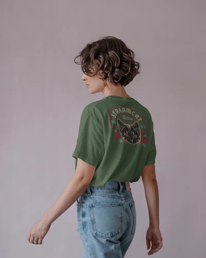 Pastel Studio T Shirt Mockup Female Model In Light Denim Turning Sideways Back View Focus
