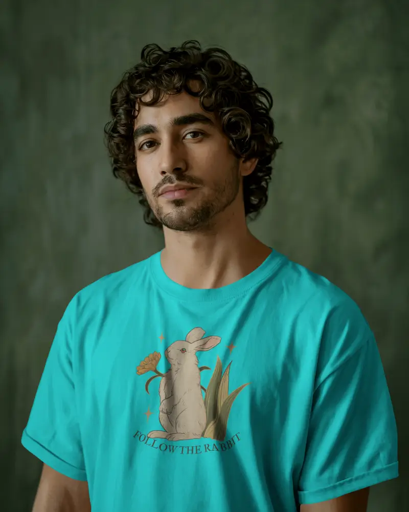 Stylish Male Model Wearing T Shirt Standing In Front Of Muted Green Texture Perfect For Lifestyle Brands