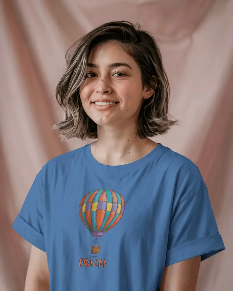 Casual T Shirt Mockup On Happy Young Woman In Front Of Gentle Blush Pink Studio Backdrop
