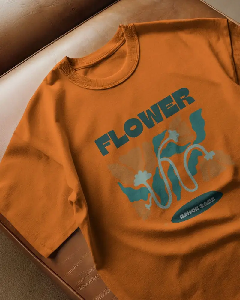 Flat Lay Tshirt Mockup On Leather Sofa Soft Lighting Relaxed Setting Natural Folds Visible