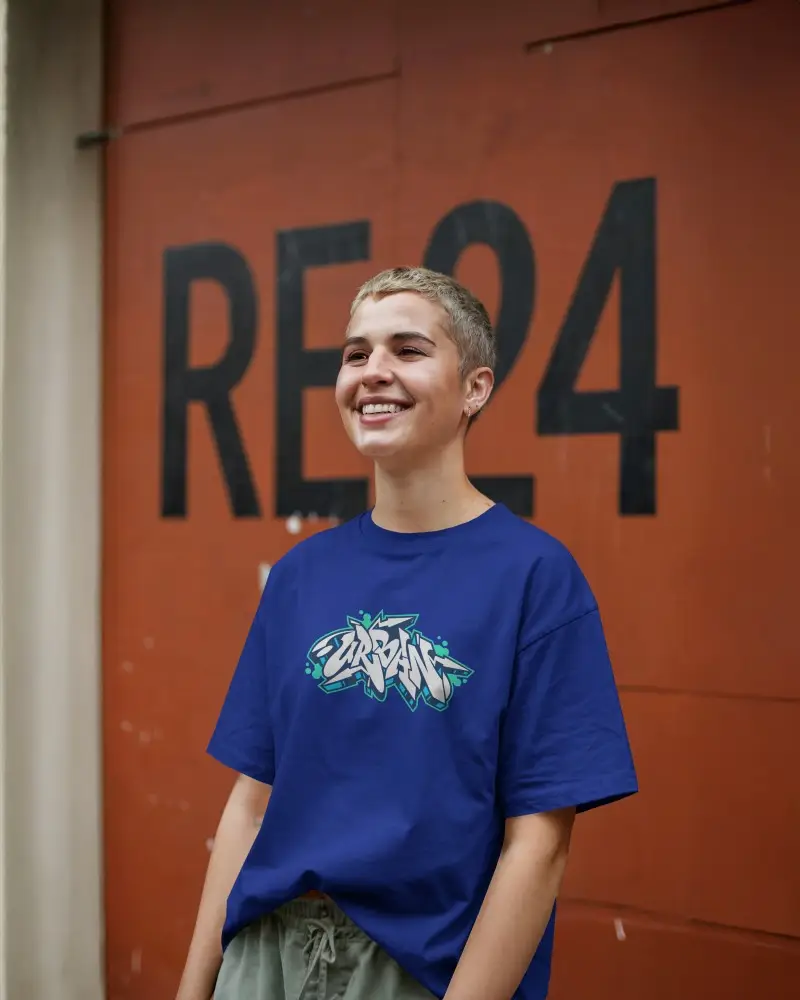 Urban Streetwear Tshirt Mockup Smiling Model In Front Of Red Industrial Wall
