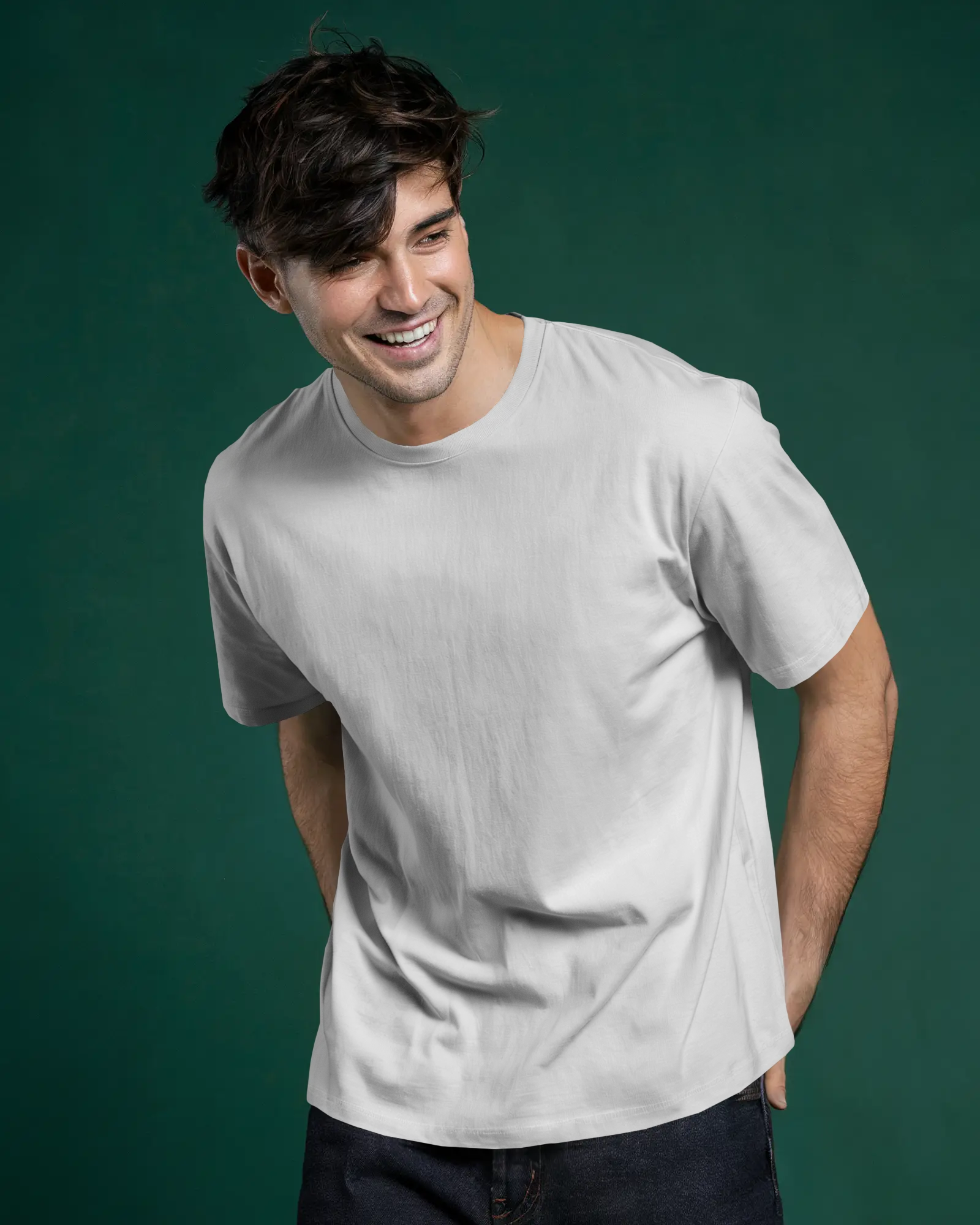 Studio Lighting T Shirt Mockup Smiling Man Wearing White Tee On Dark Green Backdrop Modern Fit Style With Relaxed Pose Casual Fashion Vibe