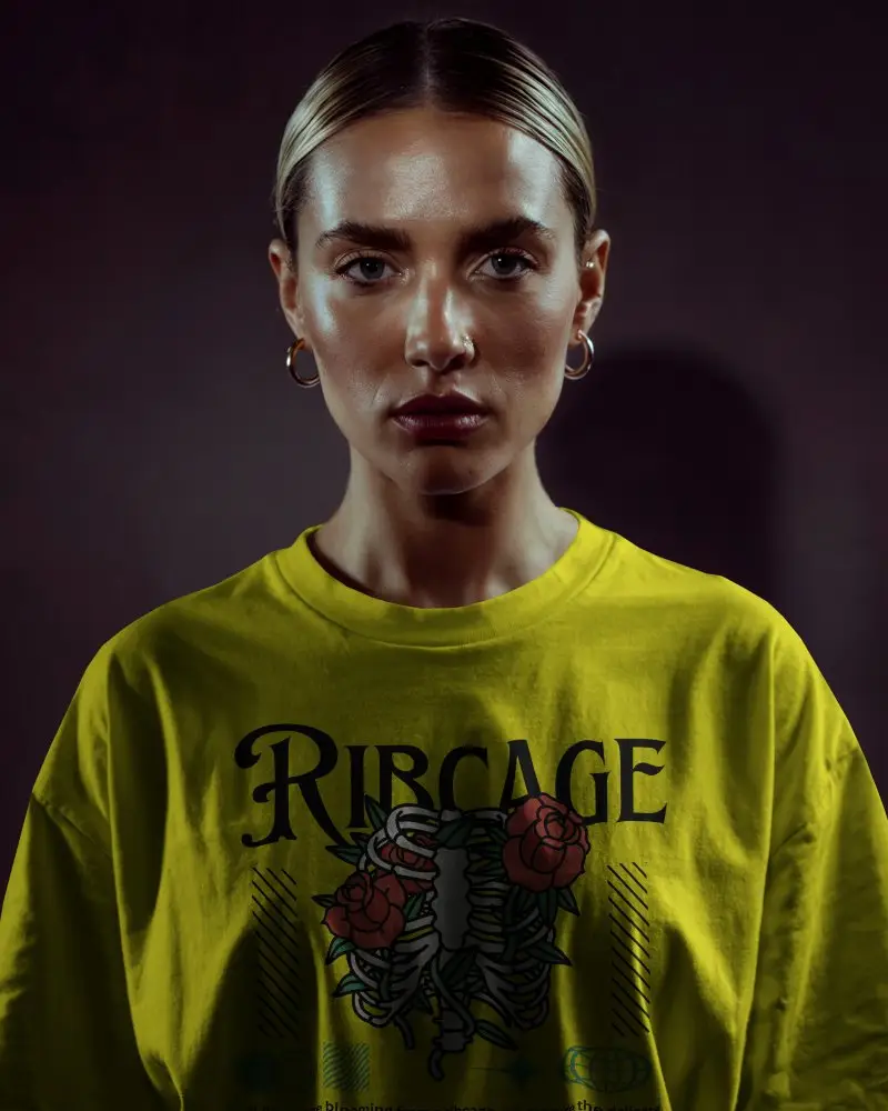 Dramatic Studio Tshirt Mockup Female Model With Bold Expression Dark Background And Spotlight Effect High Fashion Branding Shot